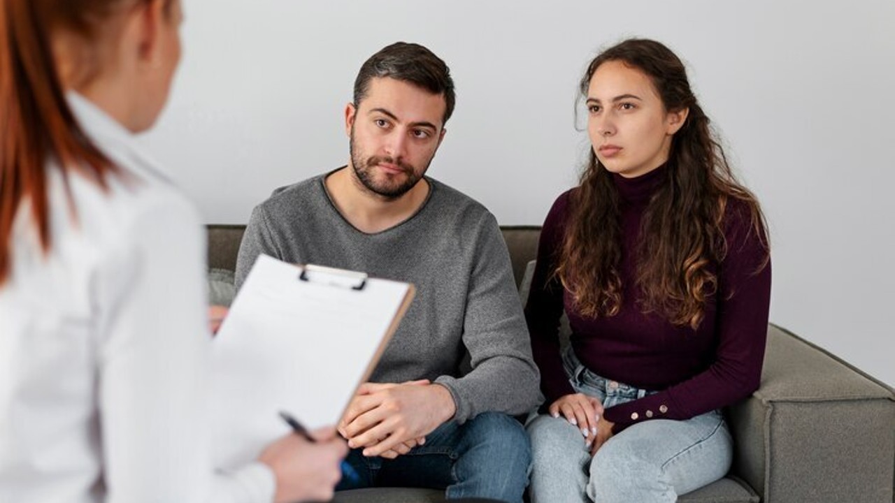 Couple consulting with a fertility specialist, discussing infertility treatment options and considerations